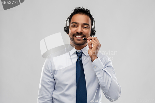 Image of indian businessman or helpline operator in headset