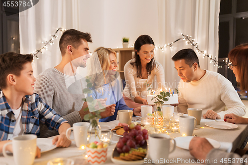 Image of happy family having birthday party at home