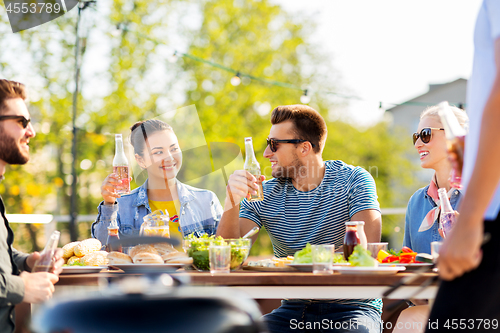 Image of friends having dinner or bbq party on rooftop