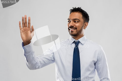 Image of indian businessman working with virtual screen