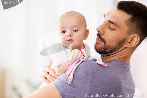 Image of father with little baby girl at home