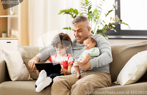 Image of happy father with preteen and baby son at home