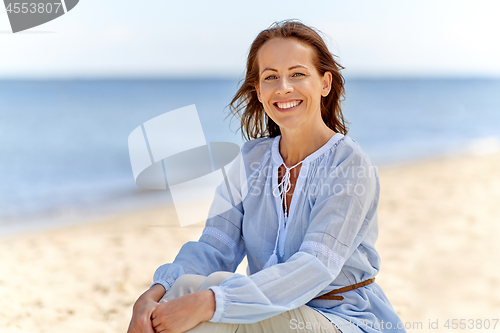 Image of happy smiling woman on summer beach