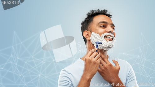 Image of indian man shaving beard with razor blade