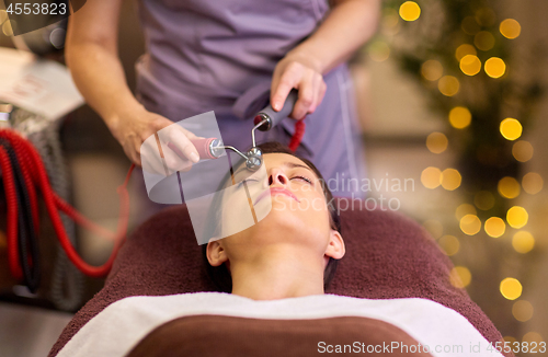 Image of woman having hydradermie facial treatment in spa