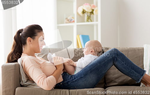 Image of happy mother with little baby boy at home