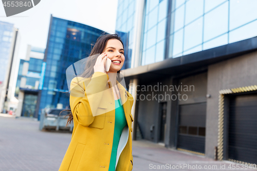 Image of smiling young woman or girl calling on smartphone