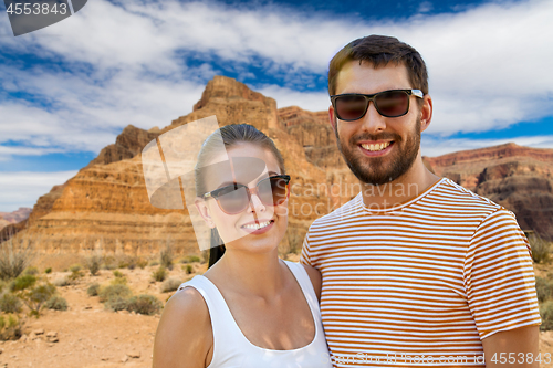 Image of happy couple in sunglasses outdoors in summer