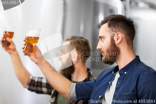 Image of men drinking and testing craft beer at brewery