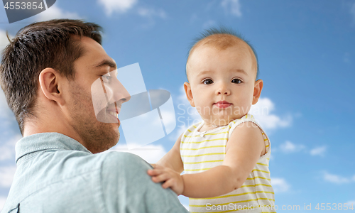 Image of father with little baby daughter at home