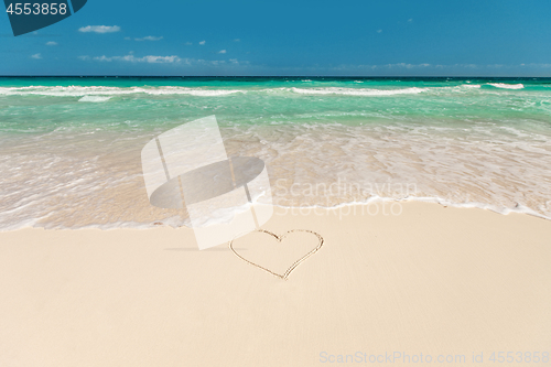 Image of tropical beach with heart on sand