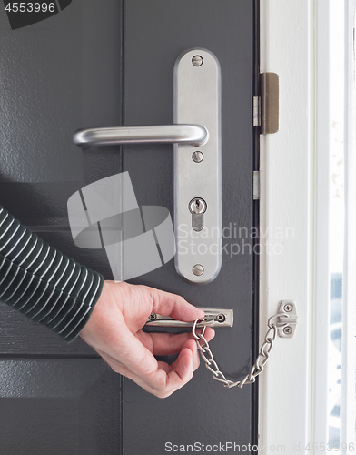 Image of Door chain on a grey door