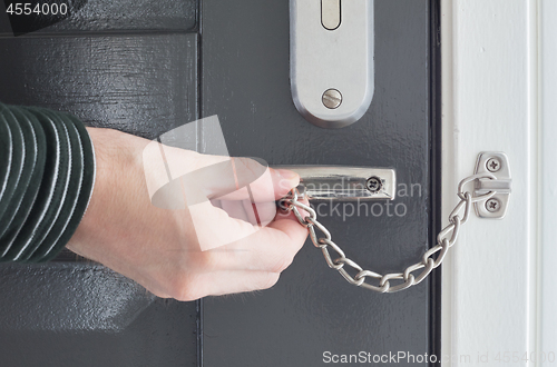 Image of Door chain on a grey door