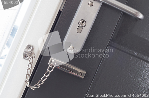 Image of Door chain on a grey door