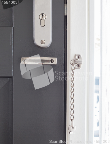 Image of Door chain on a grey door