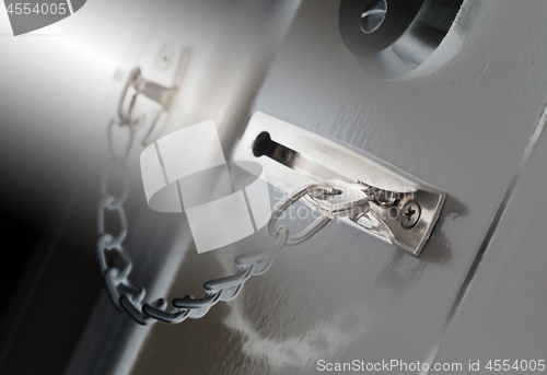 Image of Door chain on a grey door