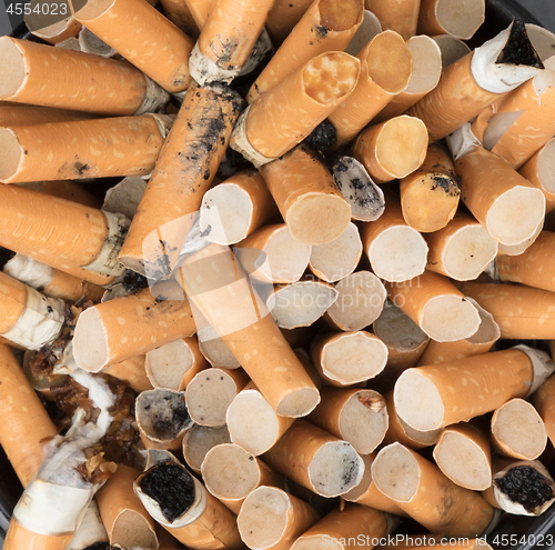 Image of Overflowing ashtray, chain smoking