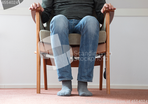 Image of Man in armchair, slightly creepy 