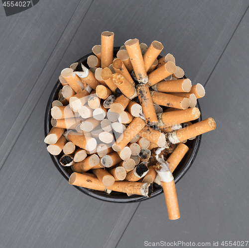 Image of Overflowing ashtray, chain smoking