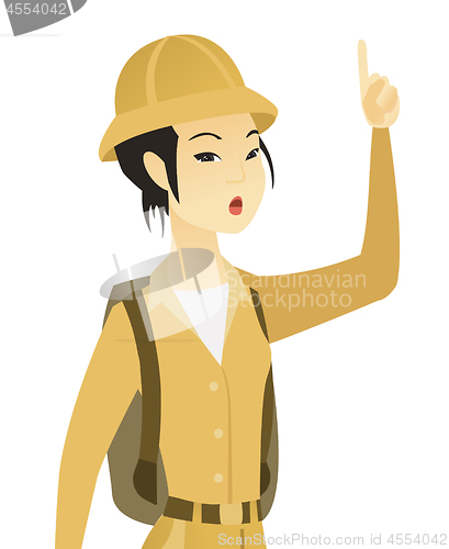 Image of Asian traveler with open mouth pointing finger up.