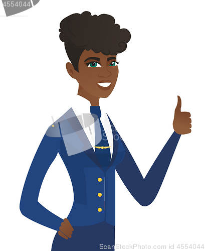 Image of Young african-american stewardess giving thumb up.