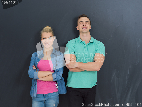 Image of couple in front of gray chalkboard