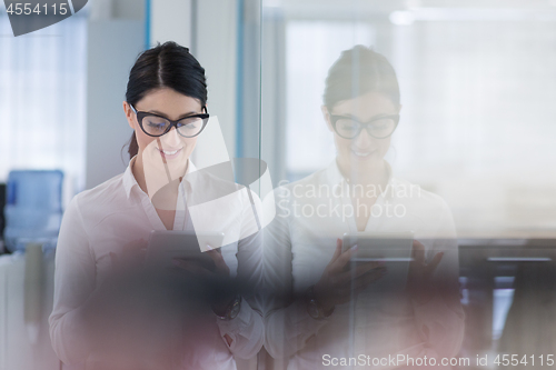 Image of Business Woman Using Digital Tablet in front of startup Office