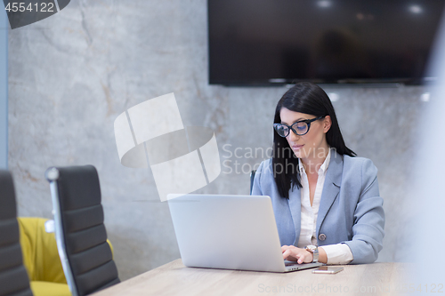 Image of businesswoman using a laptop in startup office