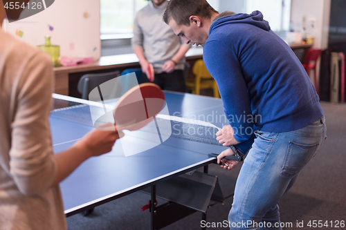 Image of startup business team playing ping pong tennis