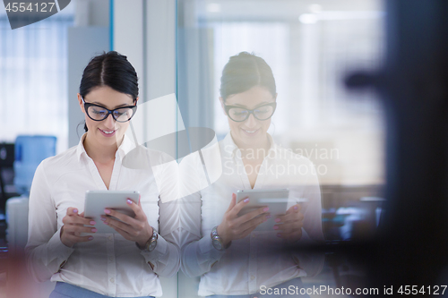 Image of Business Woman Using Digital Tablet in front of startup Office