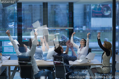 Image of startup Group of young business people throwing documents