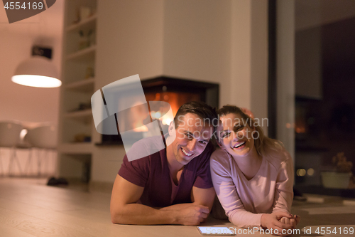 Image of Young Couple using digital tablet on cold winter night