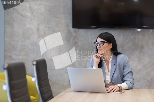 Image of businesswoman using a laptop in startup office