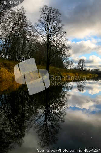 Image of Autumn landscape with colorful trees, yellow grass and river. Re