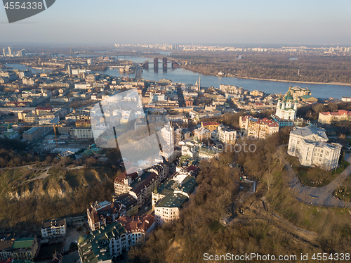 Image of A bird\'s eye view, aerial view shooting from drone of the Podol district, oldest historical center of Kiev, Ukraine, the Dnieper River and the left bank of Dnieper