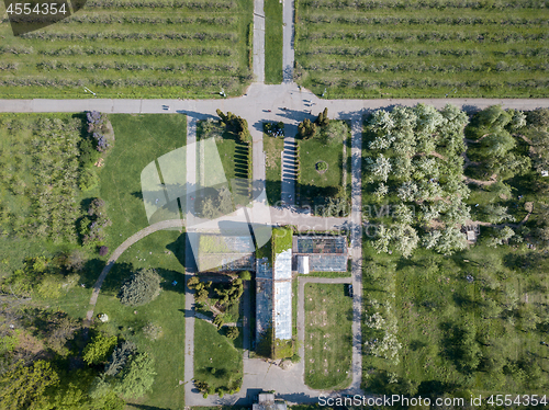 Image of Aerial view shooting from drone of the symmetrical plot with greenhouses, gardens and sown gardens at the National Exhibition Center in Kiev, Ukraine at sunset in the summer.