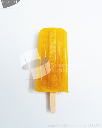 Image of Ice lollies. Orange fruit ice cream presented on a white background with copy space. Top view