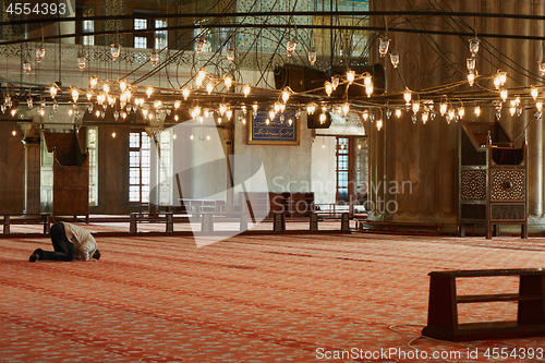 Image of male Muslim praying in the mosque