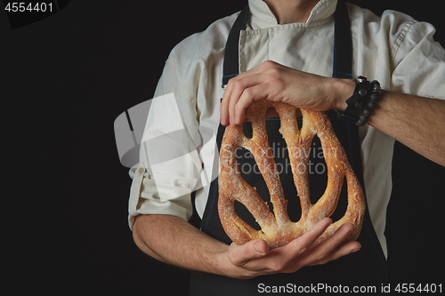 Image of Hands men holding fougas bread