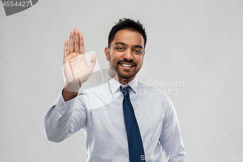 Image of indian businessman making high five gesture