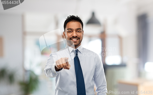 Image of businessman pointing to you over office