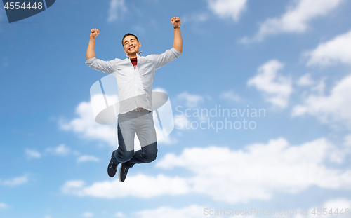 Image of happy young man jumping over white background