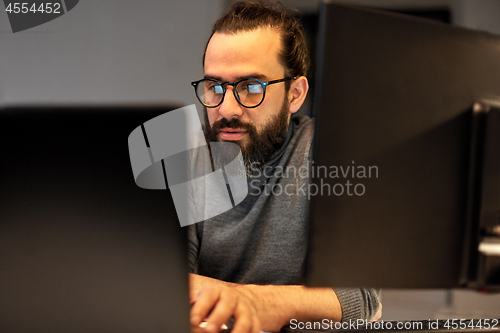 Image of close up of creative man working at night office