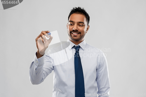 Image of indian businessman in shirt with tie over grey