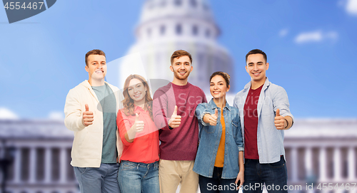 Image of friends showing thumbs up over capitol building