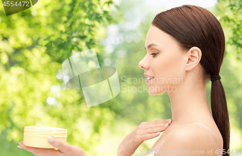 Image of beautiful woman with moisturizing cream