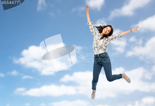 Image of happy young woman or teenage girl jumping