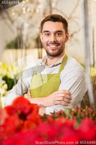 Image of florist man or seller at flower shop counter