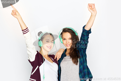 Image of teenage girls in earphones listening to music