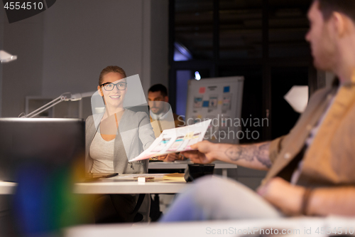 Image of designers or software developers at night office